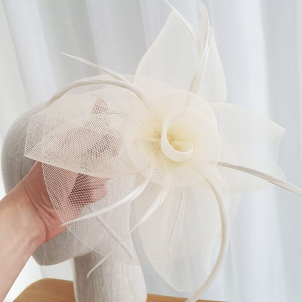 light ivory, white fascinator in a floral design.