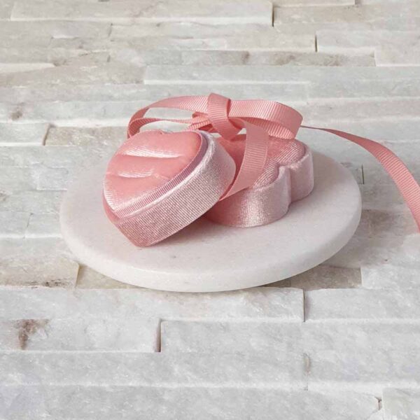Pink heart wedding ring box with bow ribbon.